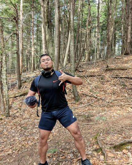 Me with headphones in the middle of the forest with a recorder at hand.