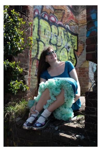 Photo of Marie Vibbert in a blue dress with a ruffly mint green hem