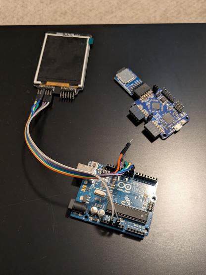 An Arduino Uno wired to an LCD, and an iCEBreaker FPGA board with a micro SD PMOD adapter.
