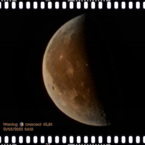 AI alt text:
A photograph of the waning crescent moon, taken on May 21, 2025, at 04:01, showcases 43.6% illumination. The left side of the moon is partially lit, while the right side fades into darkness, emphasizing the lunar phase. Visible details include craters and lunar maria, offering a textured view of the moon’s rugged surface. The image features a filmstrip-style border, adding a vintage aesthetic. A small text overlay in the bottom left corner provides information about the lunar phase, illumination percentage, and timestamp, reading: 'Waning 🌘 crescent 43,6% 21/05/2025 04:01'.