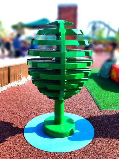 A classic green, bulbous lego tree blown up in size to about chest height and integrated into the park environment. I blurred the background.
