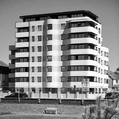 Photo of a new residential block designed by  ECE Architecture for Trinity Homes, 2024. 33 apartments across 5 to 8 storeys. Facing the new Hove Beach Park which has recently opened. 239 Kingsway, City of Brighton & Hove, UK.