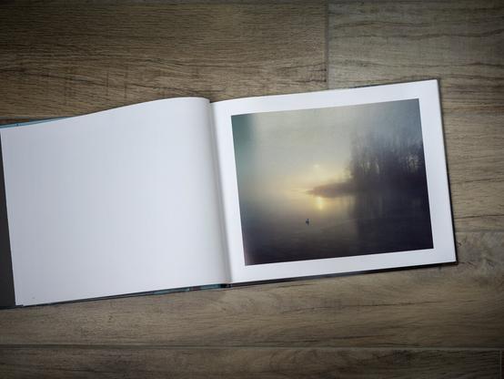 Photobook WERD by Marco Zedler 

The sun rises over the misty Rhine. A swan swims alone on the calm waters of the river. Here at the end of Lake Constance, where its waters become the Rhine again, lies the small monastery island of Werd.