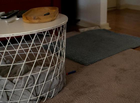 A nerf dart on carpet, a doormat in the wrong place, a coffee table/basket with most of the things removed
