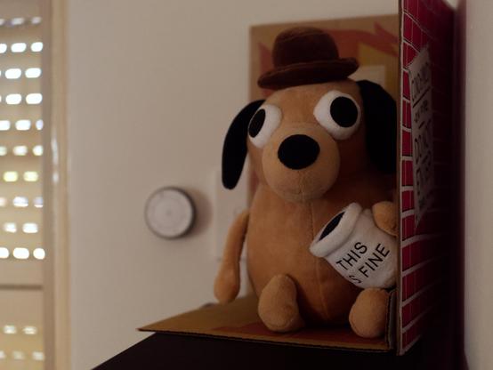 A plush of the 'This is fine" dog from K C Green's iconic webcomic