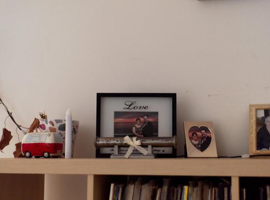 Wedding photos, a dead plant, a partially emptied bookshelf top. Nobody took these with them.