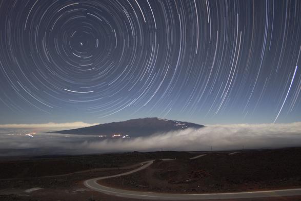2005 December 20

Star Trails Above Mauna Kea
 * Credit & Copyright: Peter Michaud (Gemini Observatory), AURA, NSF

Explanation: 
Is there a road to the stars? Possibly there are many, but the physical road pictured above leads up to the top of a dormant volcano that is a premier spot on planet Earth for observing stars and astronomical phenomena. At the top of Hawaii's Mauna Kea are some of the largest optical telescopes on Earth, including the Keck telescopes, Gemini, Subaru, CFHT, and the IRTF. Together, these 10-meter eyes have made many universe-redefining discoveries, including detailing that most of the universe is made not of familiar matter but of mysterious dark matter and dark energy. The above picture was compiled from over 150 one-minute exposures from a digital camera. During that time, the rotation of the Earth made the stars far in the distance appear to have long star trails. The foreground landscape was illuminated by the Moon.

Authors & editors: Robert Nemiroff (MTU) & Jerry Bonnell (USRA)
NASA Web Site Statements, Warnings, and Disclaimers
NASA Official: Phil Newman Specific rights apply.
A service of: ASD at NASA / GSFC
& Michigan Tech. U.