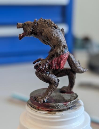 Side view of a werewolf mini on top of a medicine bottle