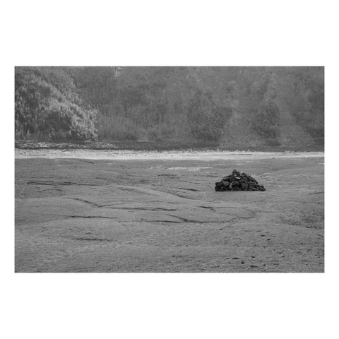 stacked stone cairn alone on a cooled lava lake inside crater