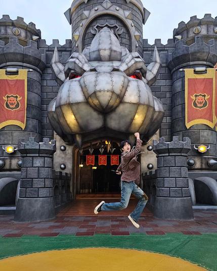 Jin jumping with glee at Universal Studios in Japan
