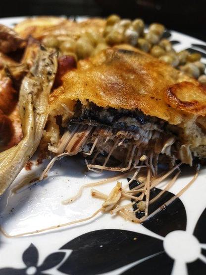 On the plate: Fish and Chips.  A close up photo of the deep fried fish.

The 'fish' is banana blossom, wrapped in Nori seaweed, dipped in batter then deep fried or air-fried. The chips are fresh potato chips baked in the oven. 
Served w/ peas, and salt and vinegar.