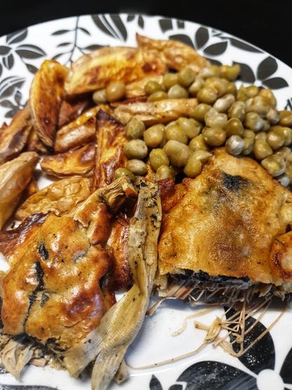 On the plate: Fish and Chips.  
 The 'fish' is banana blossom, wrapped in Nori seaweed, dipped in batter then deep fried or air-fried. The chips are fresh potato chips baked in the oven. 
Served w/ peas, and salt and vinegar.
The deep fried fish is on the right, the air fried fish on the left.
