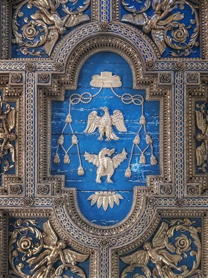 Ornate blue and gold coffered ceiling of San Crisogono Basilica in rome Italy.
