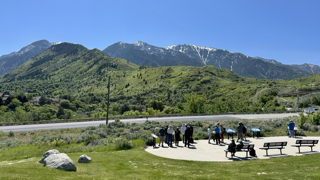 Blue sky over steep mountains with green vegetation