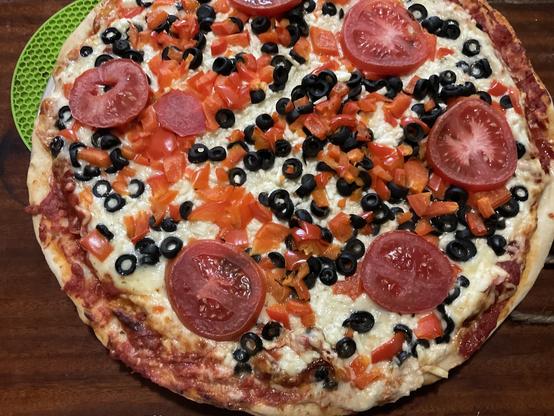 Black olives, red pepper, tomatoes, 3 cheeses including mozzarella and feta.