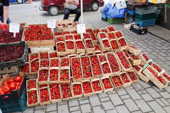 At least 60 kilos of bright red, fresh strawberries on display in large straw punnets at an outdoor market in Zakopane, Tatra Mountains. They smell, and tase, like love.