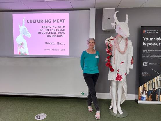 Person and cow-headed sculpture