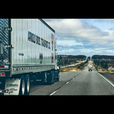 Photography in color of a big truck  on long a road , Ontario, Canada