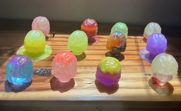 Colorful resin casts of an old doll head