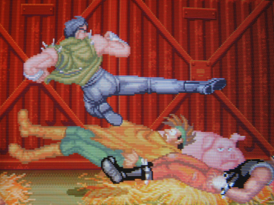 Hero character Kyle flattens two goons with a flying kick. He is facing away from camera and his butt is phenomenal. In the background a large pig is unimpressed.