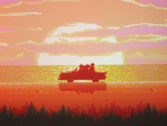 Having beaten the game, the hero characters and damsel ride off in a convertible against the backdrop of a pastel sunset.