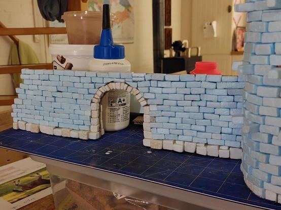 Section of castle wall made from XPS foam and cardboard. There's a rounded gate in