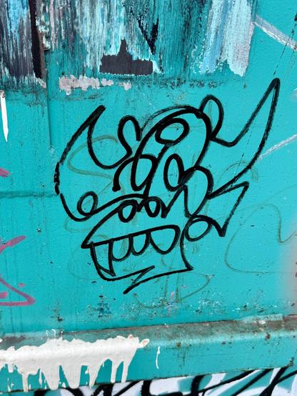 Plasmo's graffiti tag, a one-liner drawing of a gorilla, on a teal surface.