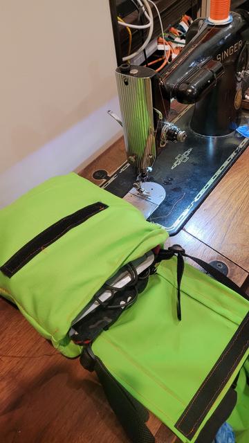 Green bag with velcro next to a Singer 201 sewing machine