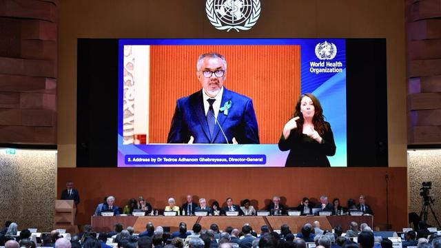 Director general on a screen with a chyron