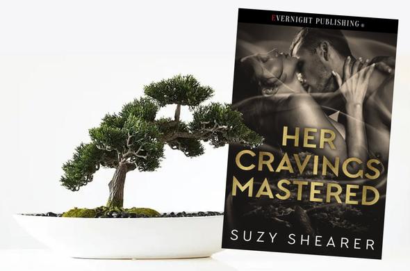 Book cover alongside a Bonsai tree.
Cover shows a man and woman embracing. Cover is coloured in greys & sepias with gold writing - Her Cravings Mastered.