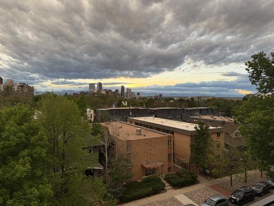 Sunset showing the Denver skyline and the Rocky Mountains in the distance.