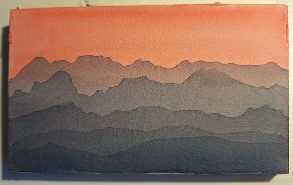 A 5x7 inch watercolor painting shows a series of blue mountains that appear to get hazier with distance and fade into the red sky. The sky is deeper red at the very top and gets slightly lighter and seemingly brighter as it progresses down the page, a result of the translucent nature of watercolor. This is just a study painting, but the artist kinda digs it.
