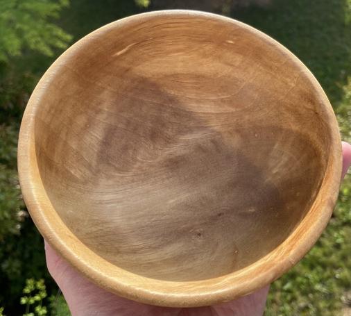 A golden brown bowl, traditionally bowl-shaped, with dramatic grain.