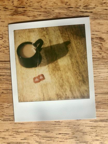 A Polaroid photo of a cup of tea.