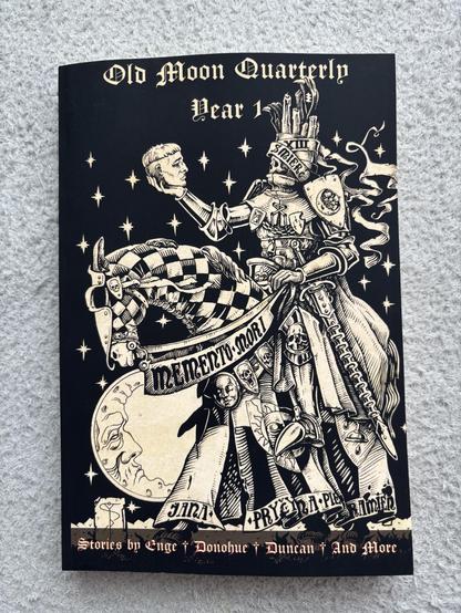 The cover of the Old Moon Quarterly Year 1 collection, showing a monochrome illustration of a mounted knight examining a severed head.
