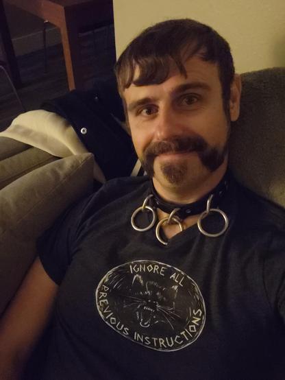 Me (a middle aged white guy with a handlebar mustache) wearing a tshirt that says "Ignore all Previous Instructions" with an angry looking racoon.