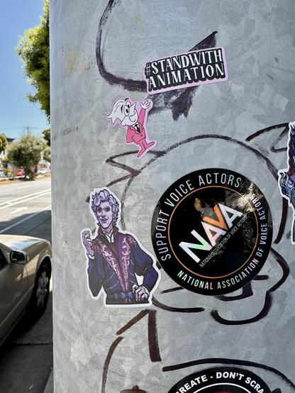 Several stickers on a post. One is a sticker of Asterion from Baldur’s Gate 3. Another sticker says “#StandWithAnimators”. Another sticker says “Support voice actors”