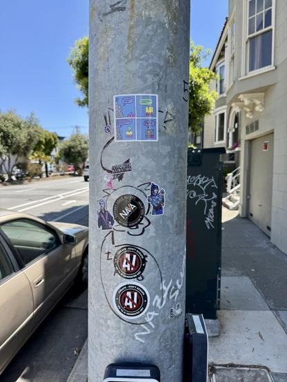 A photo from further away, showing all the AI stickers, and Baldur’s Gate characters on a post on San Jose Avenue.