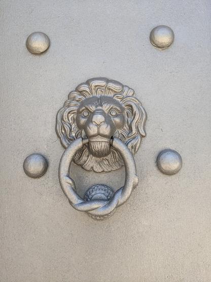One of many polished door handles in the shape of a lion