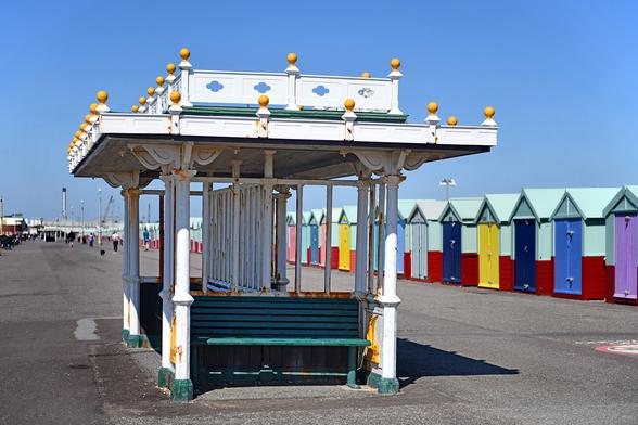 Photo of one of the Grade 2-listed seafront shelters on Hove's Western Esplanade. Built mid-C19 by Hove Corporation. Painted cast-iron and a decorative flat roof with ball finials and a quatrefoil pierced parapet. City of Brighton & Hove, UK.