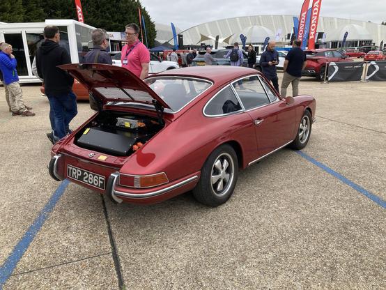 Deep red electric Porsche 912 with opened engine compartment, rear quarter view