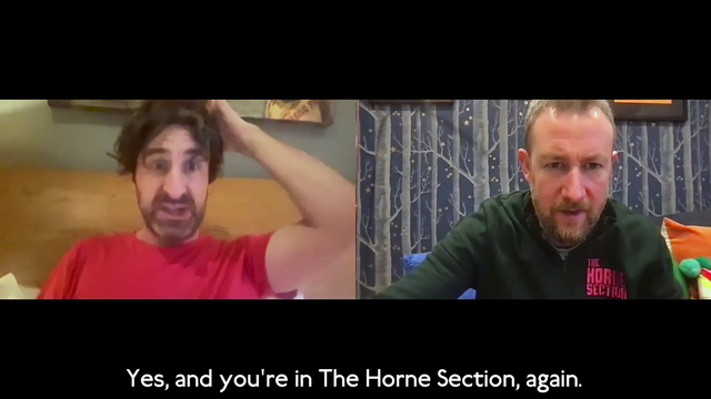 Screenshot from a Zoom call between two friends, playing a parlour game. It's just Watson and Horne. Horne is wearing a dark green tracksuit top that says "The Horne Section' on it in hot pink embroidery. Watson says "Yes, and you're in The Horne Section, again."