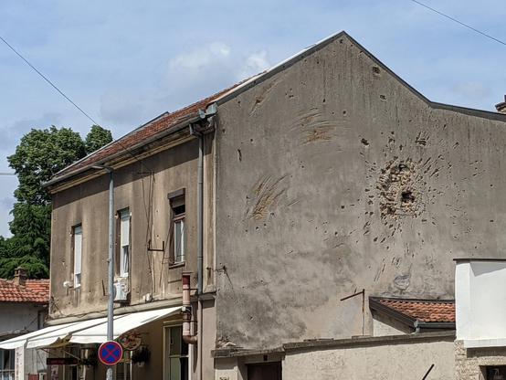 Old building with shrapnel holes in the wall