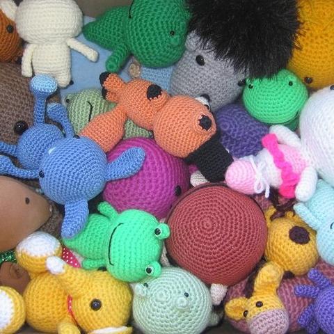 A picture of the inside of a box filled with all sorts of amigurumis.