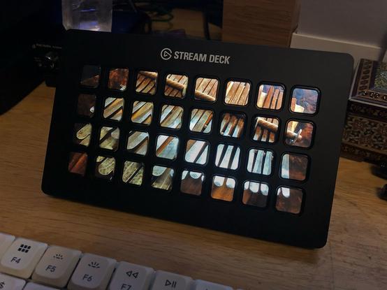 A Stream Deck XL has an 8 x 4 matrix of 32 buttons, each displaying its own LCD image.

It has a screen saver mode, and I have it displaying a photo of my mbira.