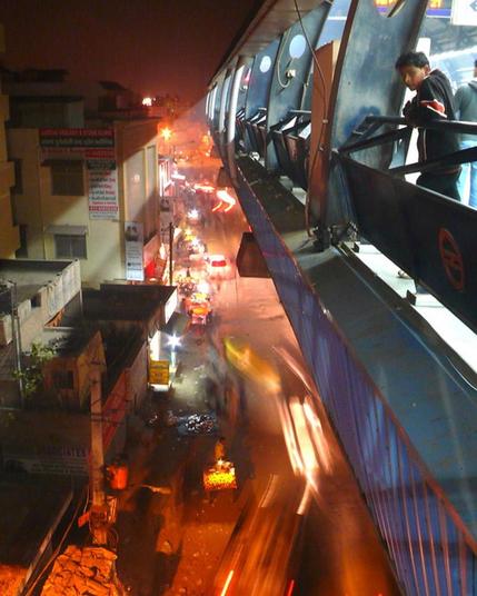 Photo of a metro platform in India overlooking a busy neighborhood with blurred vehicles in motion below.

Colin Hughes (CC BY-NC-ND 2.0)
https://flic.kr/p/bdV7w2
