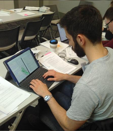 Student working on a tablet computer making a map.