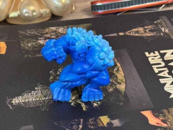 The troll from slightly above with brightened crystals on his back after the paints cured over night. It went a little darker.