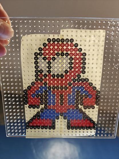 Pixel Spidey on a perler beads peg board