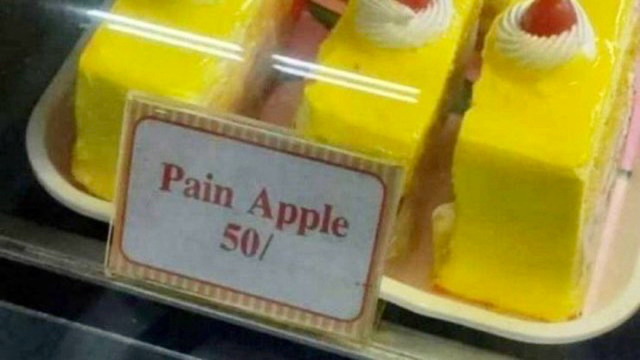 cakes in a display case with a label that reads "Pain Apple 50/"